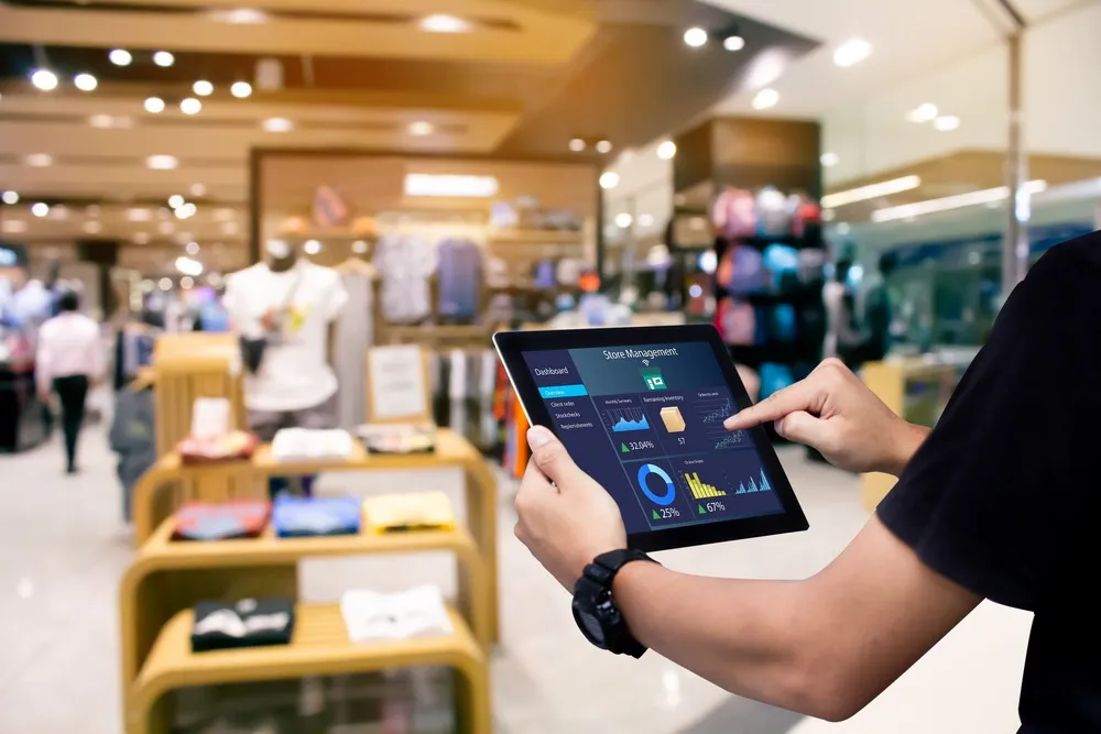 Retail employee optimizing store operations with an iPad, sourced affordably through iPadify’s bulk purchase program, demonstrating the practicality of tech in retail management.