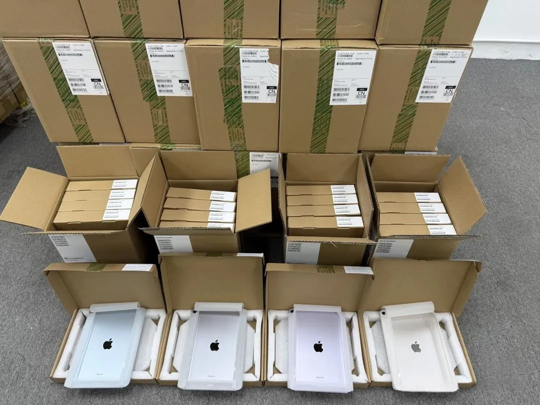 Bulk iPad units in original packaging stacked in shipping cartons ready for wholesale distribution